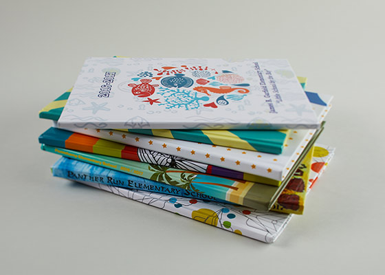 Stack of seven yearbooks on a white background Stack of seven yearbooks on a white background